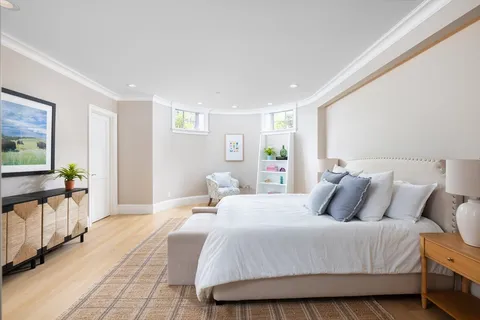 a bedroom with a large bed and a filled window