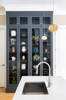 a kitchen with granite countertop a refrigerator a oven and a sink