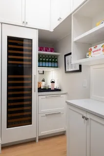 a kitchen with stainless steel appliances a stove and white cabinets