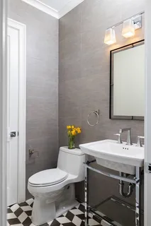 a bathroom with a sink mirror vanity and toilet