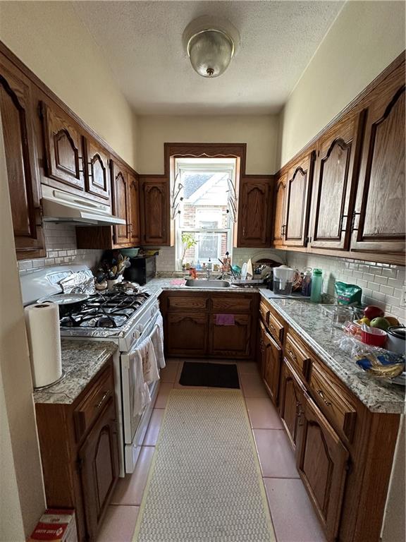 7021 Colonial Road Brooklyn, NY 11209 - Photo 4 of 15 a kitchen with a stove sink and a window