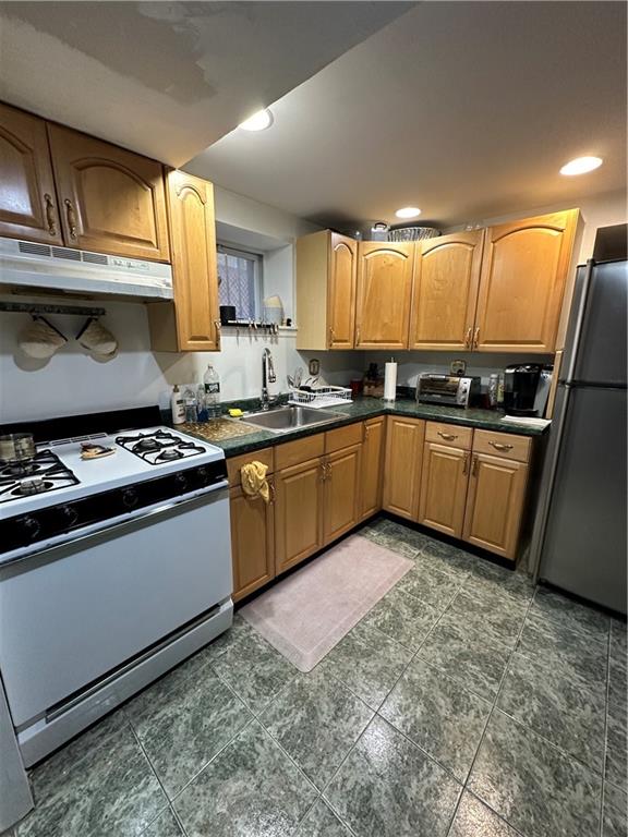 7021 Colonial Road Brooklyn, NY 11209 - Photo 7 of 15 a kitchen with stainless steel appliances granite countertop a sink a stove a refrigerator a sink a counter space and cabinets