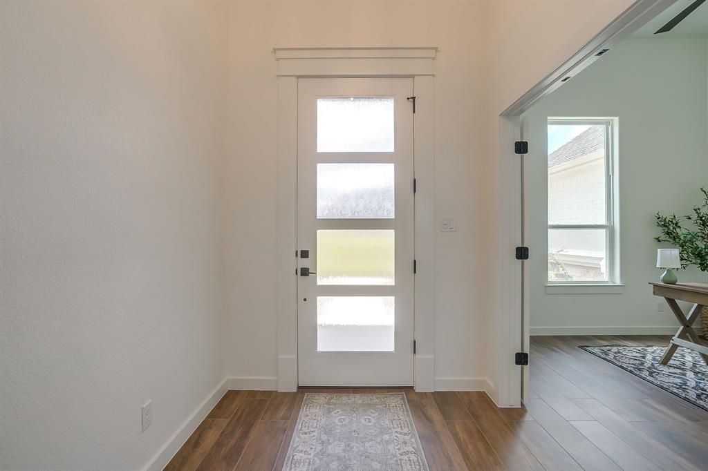 9012 Valley Oak Court Springtown, TX 76082 - Photo 5 of 40 a view of empty room with wooden floor and fan