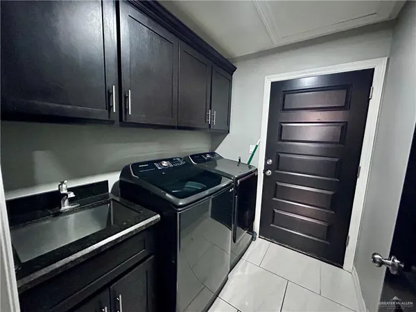 a kitchen with a sink stainless steel appliances and cabinets