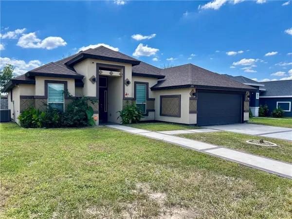 a front view of a house with a yard