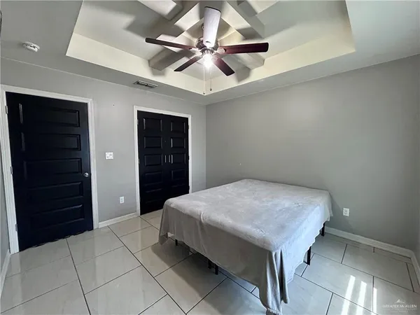 a bedroom with a bed and a ceiling fan