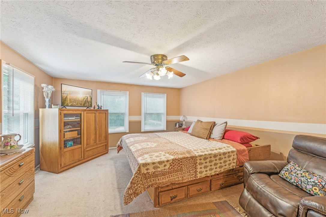 2911 Lee Road Cleveland, OH 44120 - Photo 35 of 50 Bedroom with light carpet, a textured ceiling, and ceiling fan