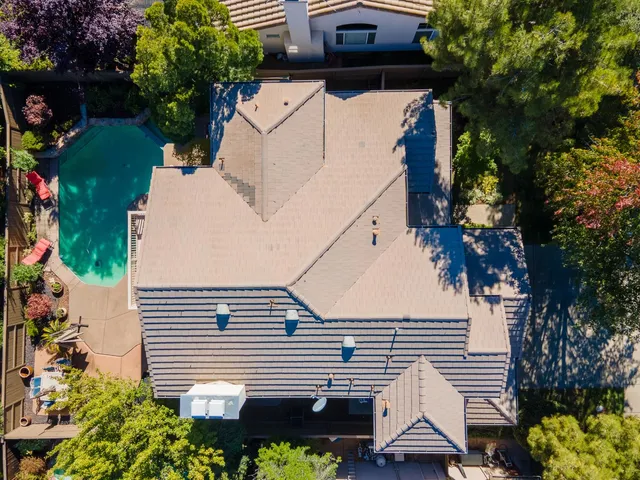 a view of a house with a patio and a yard