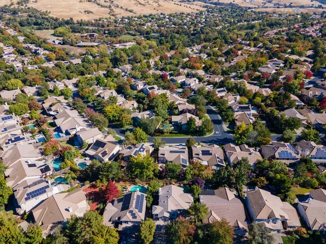 a bed sitting in a bedroom chandelier