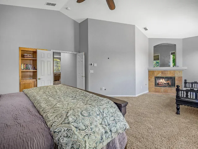 a room with furniture a air conditioner vent and white cabinets