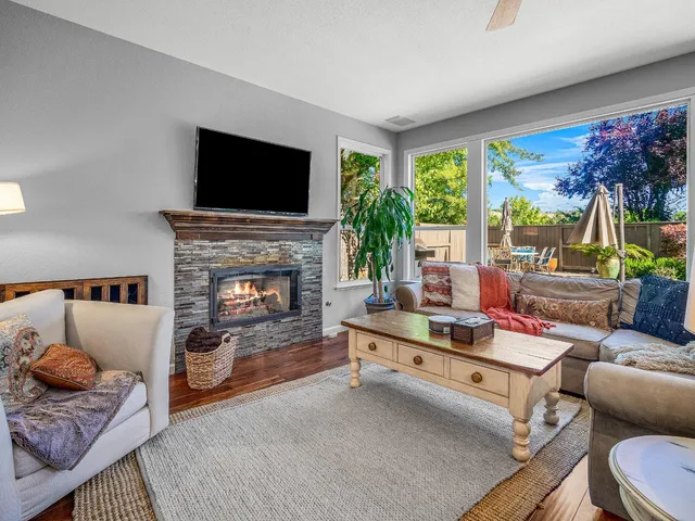 a view of a dining room with furniture a chandelier and wooden floor