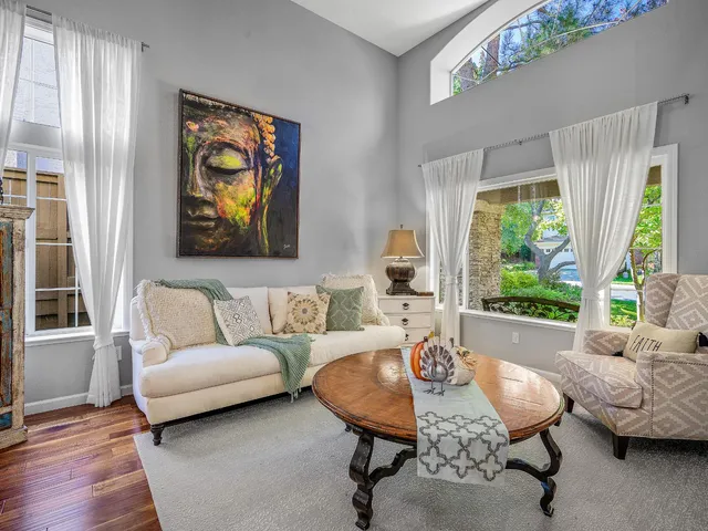 a view of a swimming pool with a garden and trees