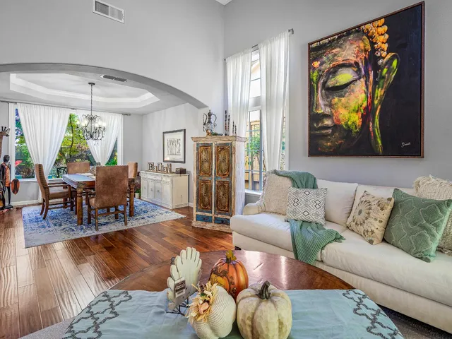 a view of a swimming pool with lounge chair and dinning table under an umbrella