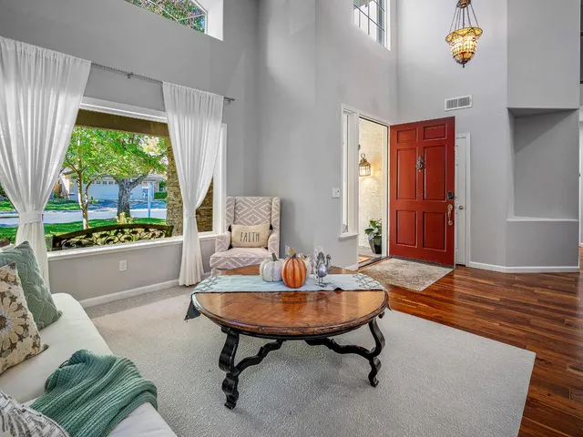 a sign board with flower garden in front of it