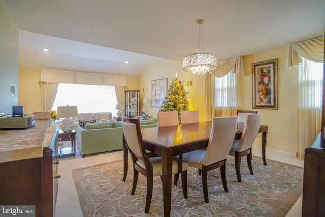 a view of a dining room with furniture and a chandelier