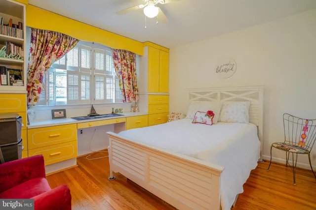 a view of a workspace with furniture and a book shelf