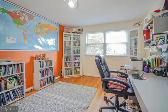 a bedroom with a bed and a desk