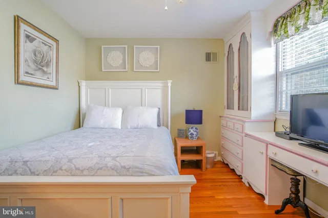 a living room with furniture and a book shelf