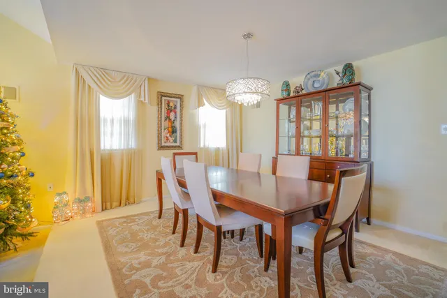 a view of a dining room with furniture and a chandelier