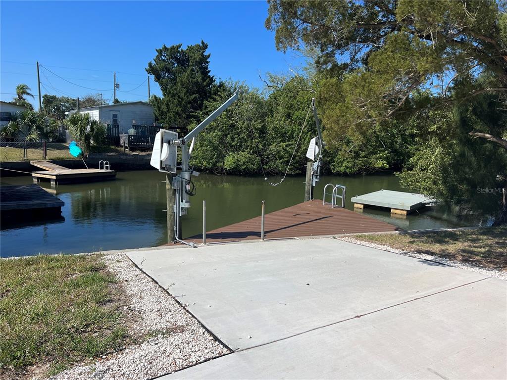 a swimming pool with outdoor seating and plants