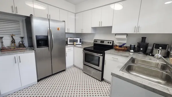 a kitchen with a sink stove and refrigerator