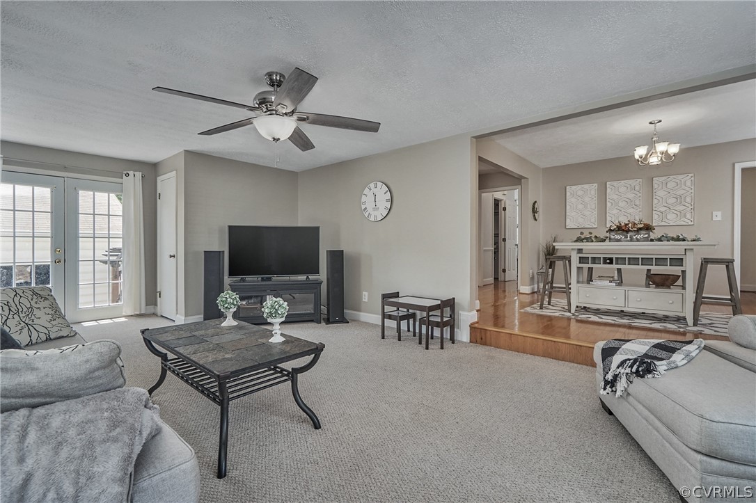 2617 Lampworth Road Henrico, VA 23231 - Photo 20 of 45 a living room with furniture a fireplace and a chandelier