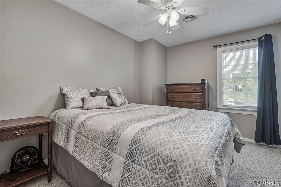 2617 Lampworth Road Henrico, VA 23231 - Photo 23 of 45 a bedroom with a bed and a chandelier
