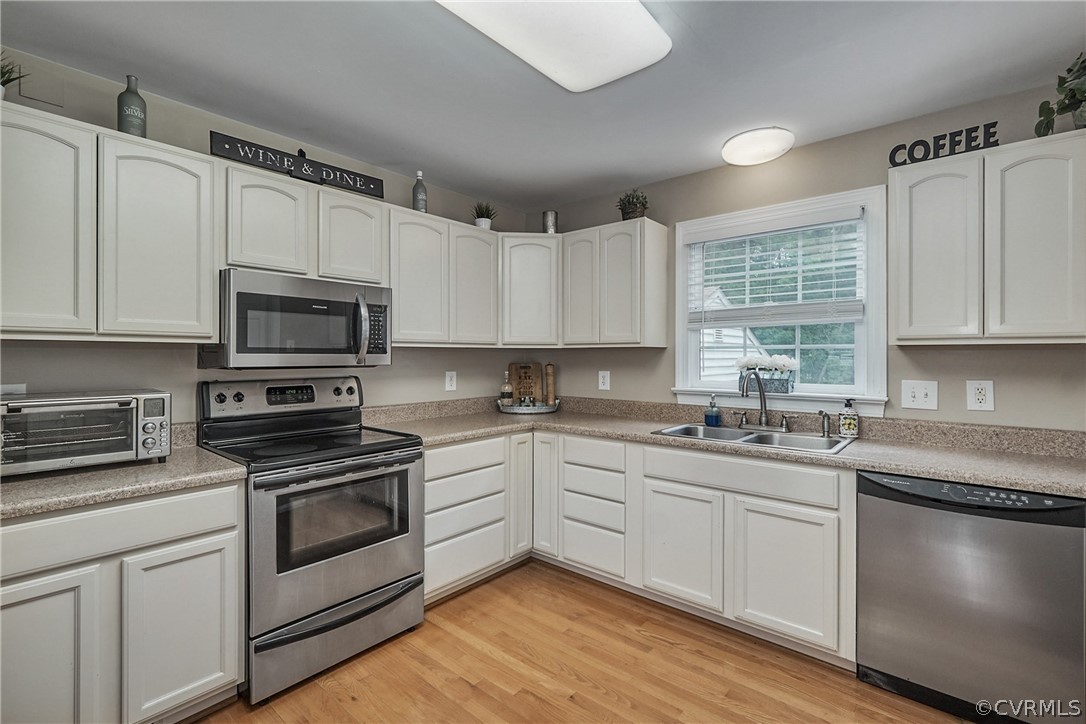 2617 Lampworth Road Henrico, VA 23231 - Photo 8 of 45 a kitchen with appliances cabinets and a sink