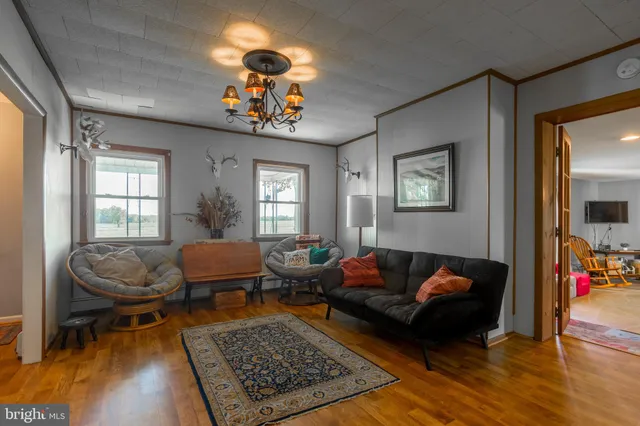 a living room with furniture and floor to ceiling window