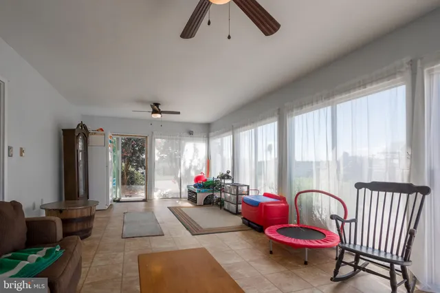 a spacious bedroom with a bed and a chandelier
