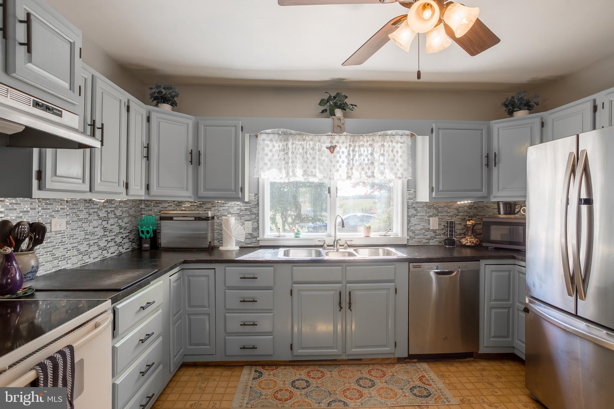 10380 Chapel Road Easton, MD 21601 - Photo 28 of 95 a kitchen with stainless steel appliances granite countertop a sink a stove a refrigerator and cabinets