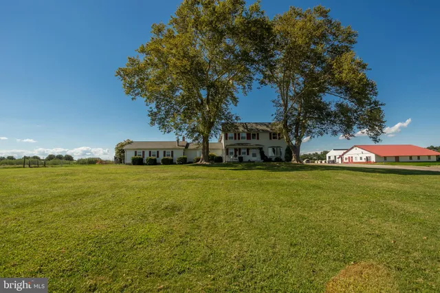 a living room with furniture a ceiling fan and a window