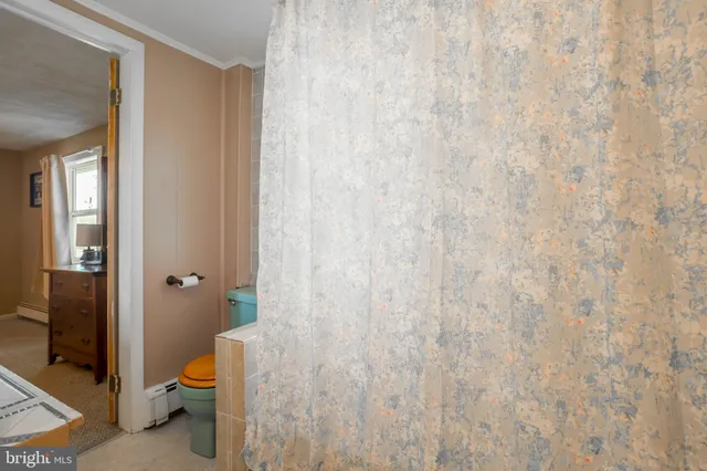 a bathroom with a sink mirror vanity and toilet
