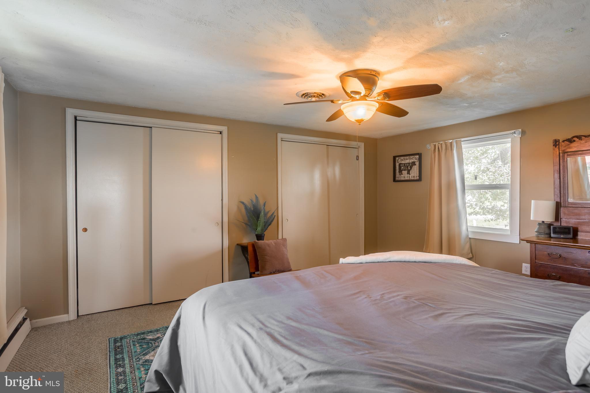 10380 Chapel Road Easton, MD 21601 - Photo 37 of 95 a bedroom with a bed and a chandelier