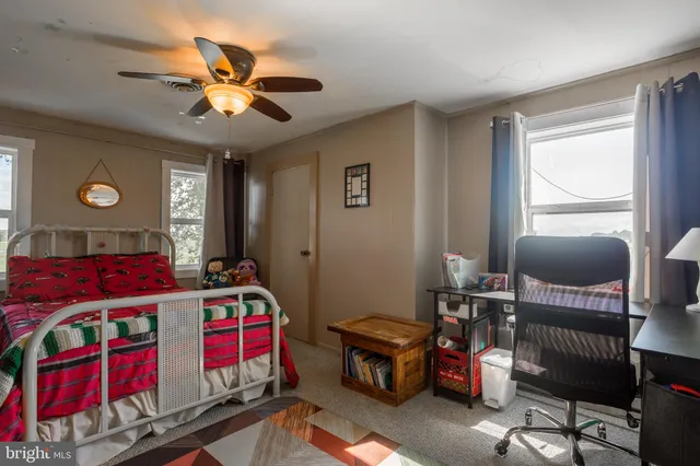 a view of a road with wooden fence