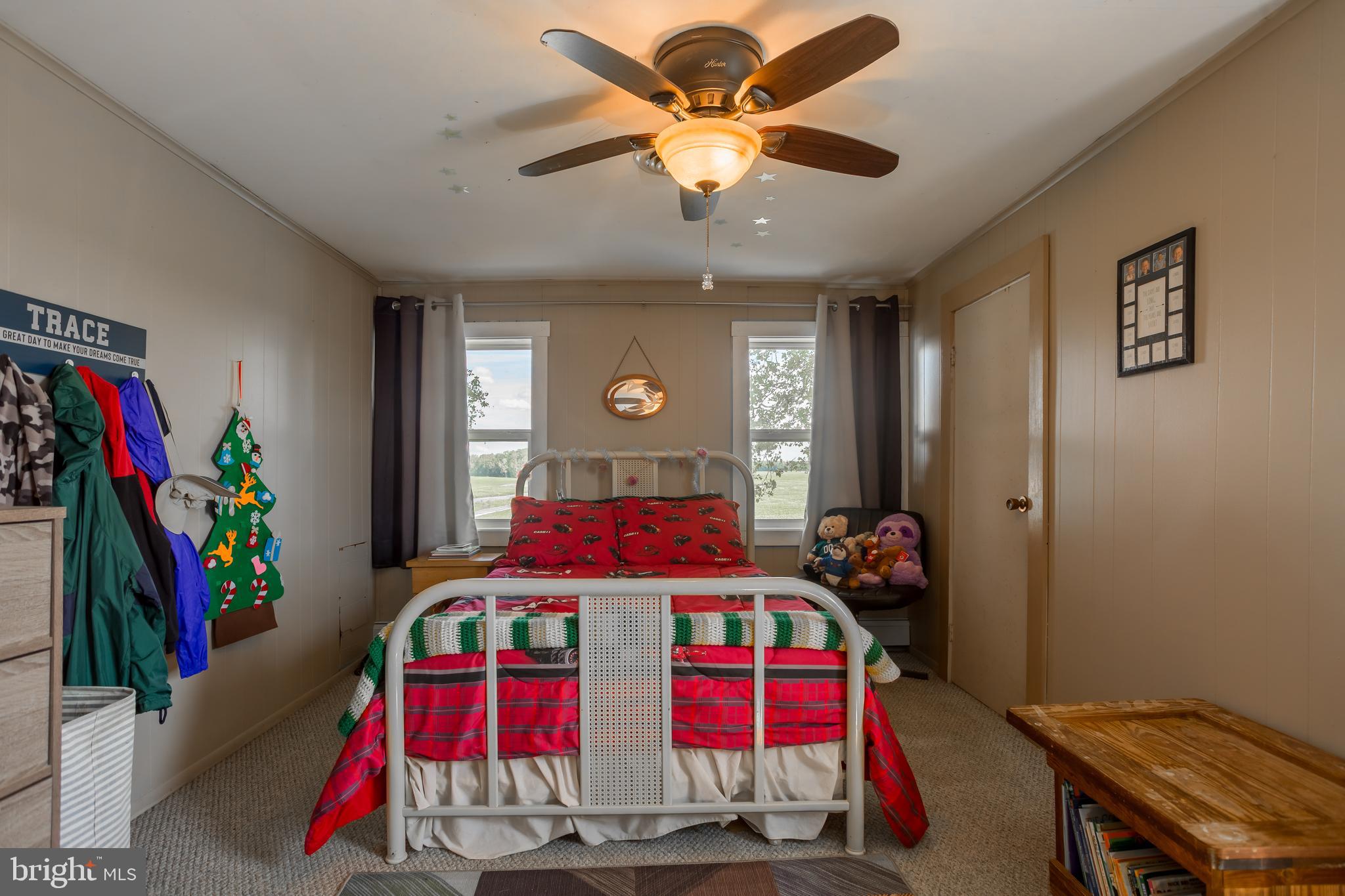 10380 Chapel Road Easton, MD 21601 - Photo 39 of 95 a bedroom with a bed a ceiling fan and a window