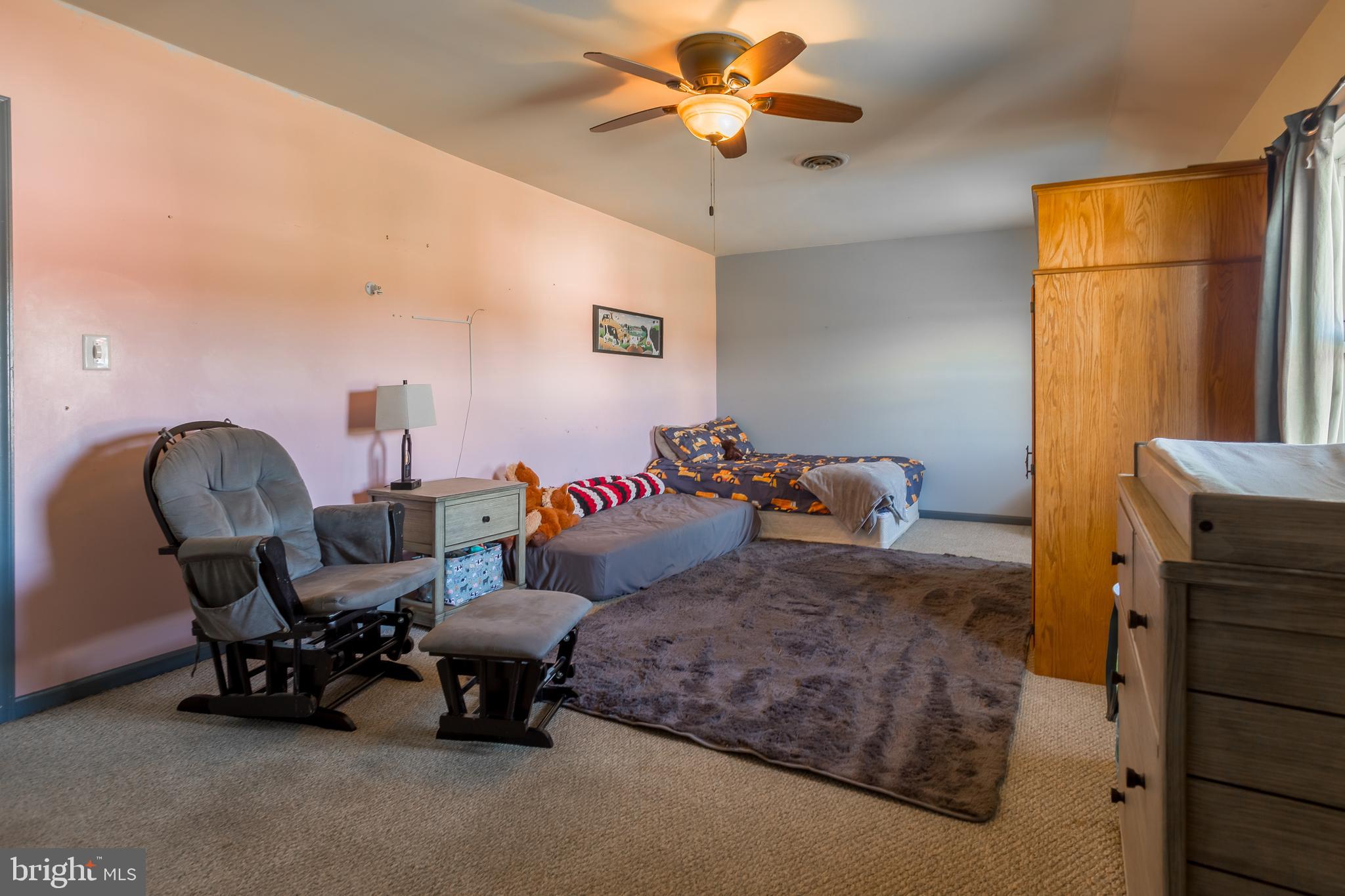 10380 Chapel Road Easton, MD 21601 - Photo 42 of 95 a bedroom with a bed a chair and potted plant on the dresser