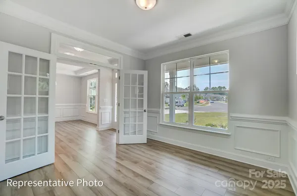 a view of wooden floor and windows in a room