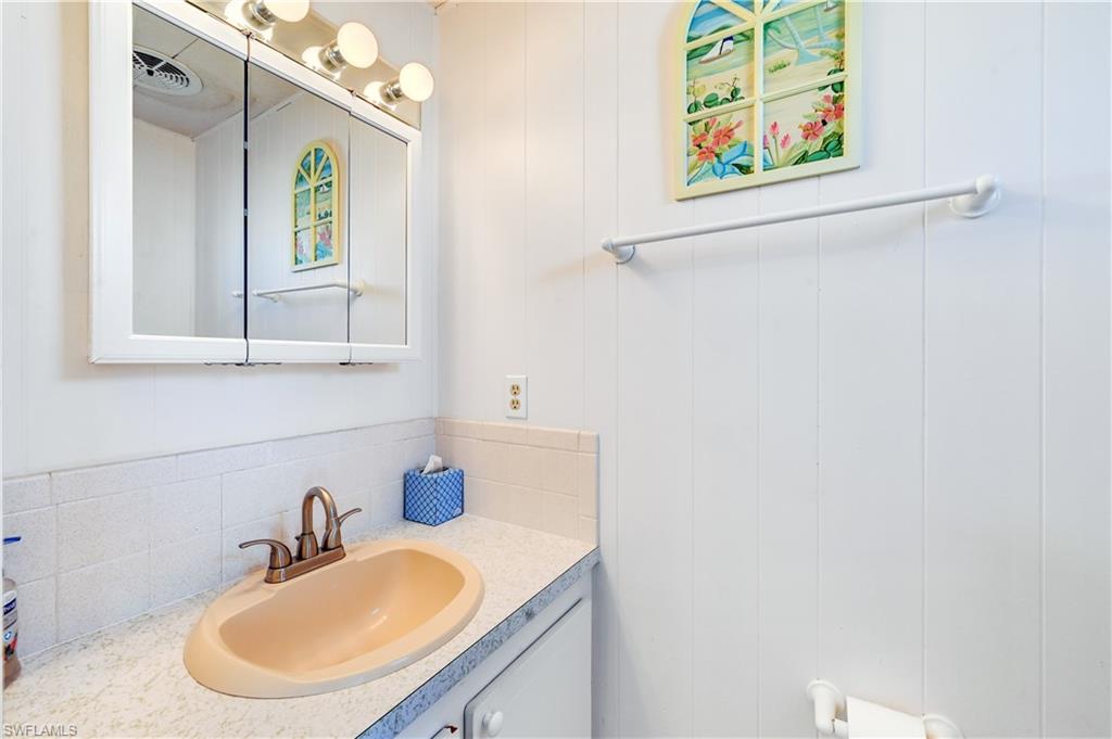 11 Moonstone Circle Naples, FL 34112 - Photo 15 of 20 a bathroom with a sink vanity and mirror