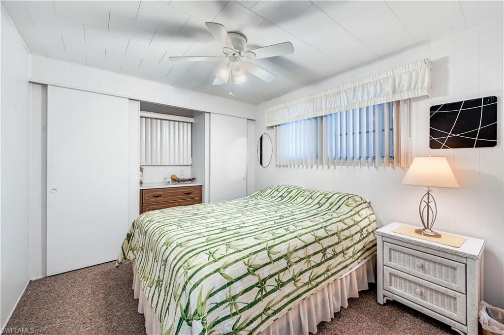 11 Moonstone Circle Naples, FL 34112 - Photo 16 of 20 a bed room with a bed and a lamp