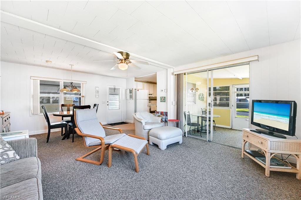 11 Moonstone Circle Naples, FL 34112 - Photo 4 of 20 a living room with furniture and a flat screen tv