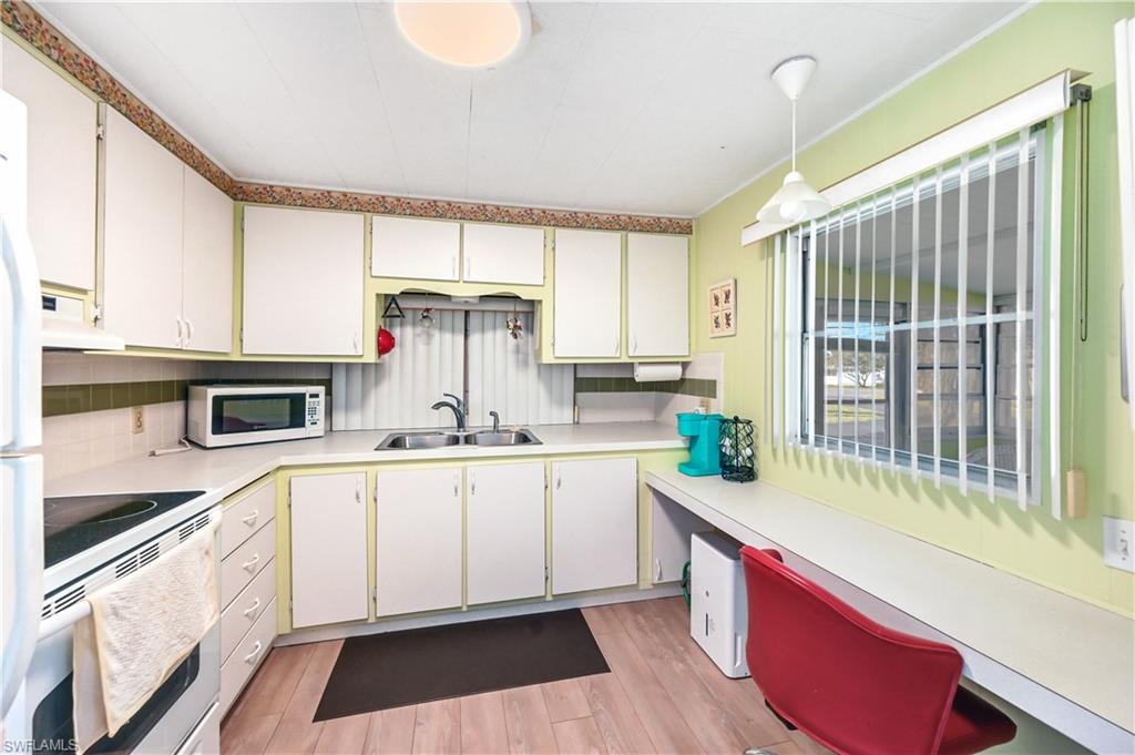 11 Moonstone Circle Naples, FL 34112 - Photo 9 of 20 a kitchen with stainless steel appliances a sink and a stove