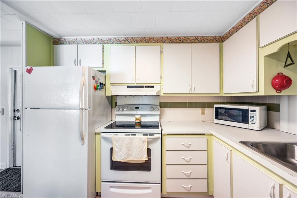 11 Moonstone Circle Naples, FL 34112 - Photo 10 of 20 a kitchen with a refrigerator and a stove