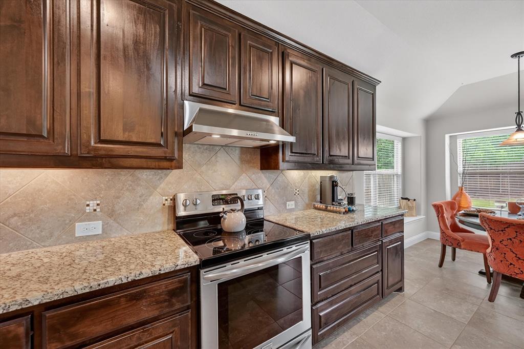 106 Zion Lane Forney, TX 75126 - Photo 12 of 37 a kitchen with granite countertop cabinets stainless steel appliances and a counter space