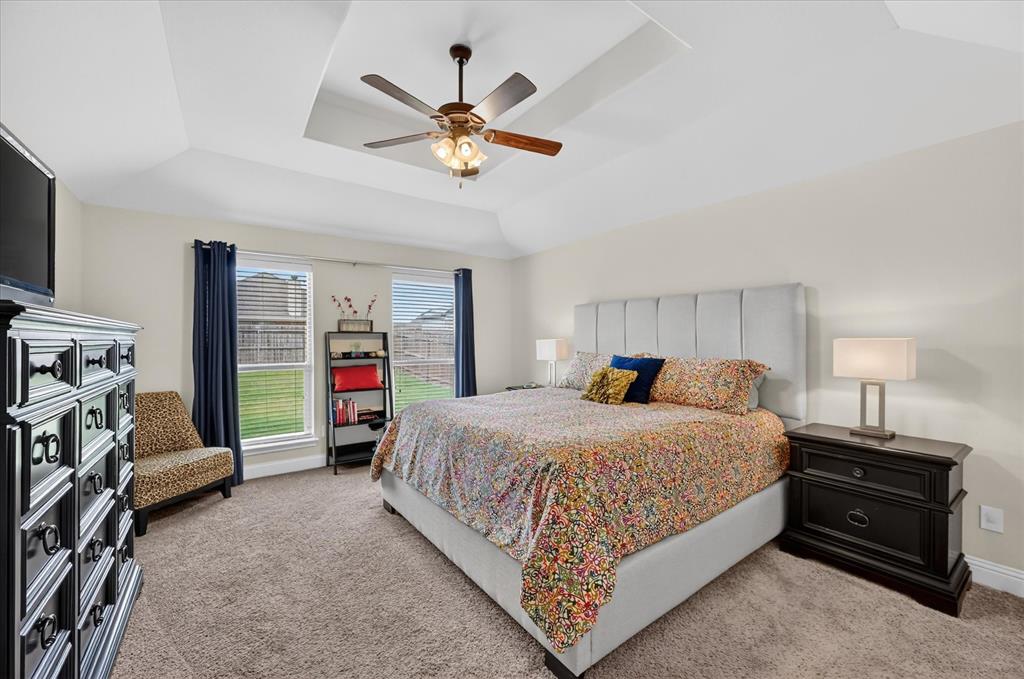 106 Zion Lane Forney, TX 75126 - Photo 15 of 37 a bedroom with a bed and a walk in closet