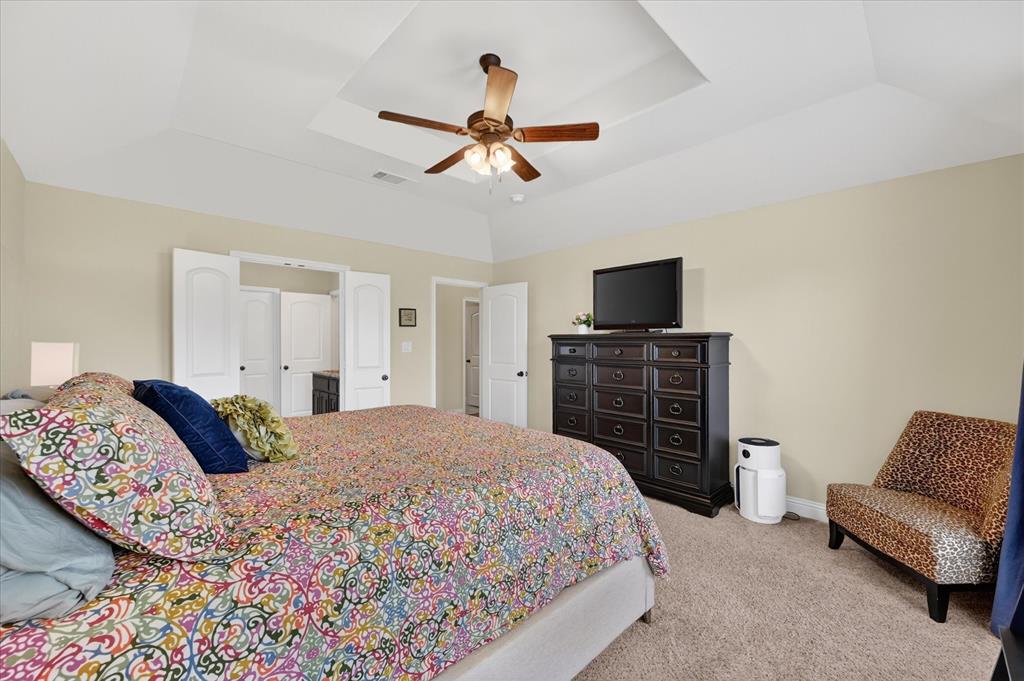 106 Zion Lane Forney, TX 75126 - Photo 16 of 37 a bedroom with a bed and a television