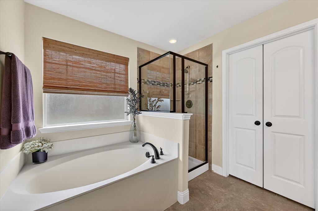 106 Zion Lane Forney, TX 75126 - Photo 18 of 37 a bathroom with a bathtub and a shower