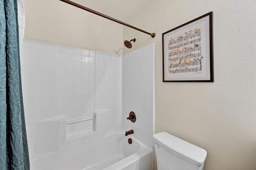 106 Zion Lane Forney, TX 75126 - Photo 23 of 37 a bathroom with a shower and toilet
