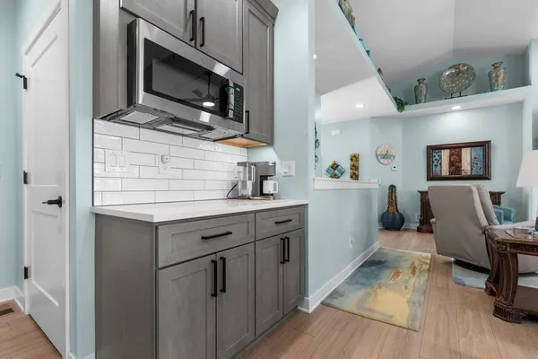 a kitchen with a sink cabinets and microwave