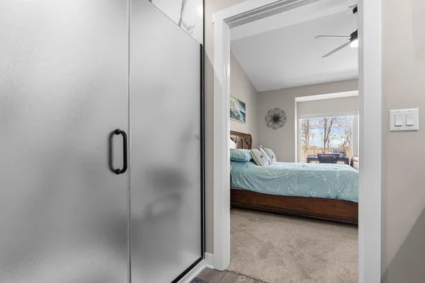 a bedroom with a bed and a window